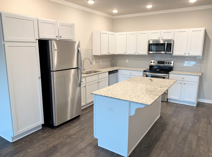 B2 (2-car) Kitchen with island, granite countertops, stainless steel appliances, white cabinets
